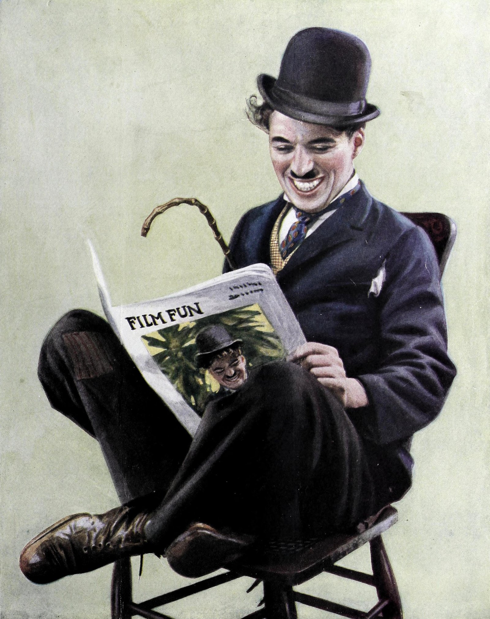 Charlie_Chaplin_reads_Film_Fun,_1915